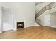 Living room with fireplace, hardwood floors, and staircase with wood and iron railing at 95113 Vance Knls, Chapel Hill, NC 27517