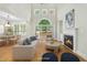 Staged living room with hardwood floors, fireplace, and sliding glass door to deck at 95113 Vance Knls, Chapel Hill, NC 27517