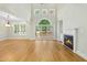 Bright living room with hardwood floors, fireplace, and sliding glass door to deck at 95113 Vance Knls, Chapel Hill, NC 27517