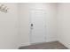 Entryway features modern gray floors and coat hooks for convenience at 97 Begonia St, Angier, NC 27501