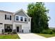 Lovely townhome featuring a one-car garage and manicured landscaping at 97 Begonia St, Angier, NC 27501