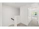 Upstairs hallway with plush carpet leading to bright, naturally-lit rooms at 97 Begonia St, Angier, NC 27501