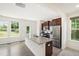 Modern kitchen with granite countertops, stainless steel appliances, and an island sink at 97 Begonia St, Angier, NC 27501