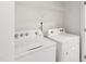 Functional laundry room with a white Whirlpool washer and dryer and wire shelving at 97 Begonia St, Angier, NC 27501