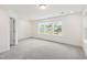 Spacious living room with abundant natural light from three large windows and plush carpet at 97 Begonia St, Angier, NC 27501