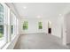 Light-filled bedroom features large windows offering views of the surrounding greenery, and neutral carpet at 97 Begonia St, Angier, NC 27501