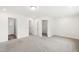Bright main bedroom featuring multiple doors to the bathroom and closet spaces, and neutral carpet at 97 Begonia St, Angier, NC 27501