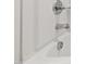 Close up of the white, built-in tub featuring chrome fixtures and drain at 97 Begonia St, Angier, NC 27501