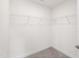 Functional walk-in closet with carpet flooring and wire shelving for organized storage at 97 Begonia St, Angier, NC 27501