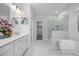 Elegant bathroom featuring marble floors, a soaking tub, and a glass-enclosed shower at 98 Priming Way, Angier, NC 27501