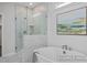 Luxurious bathroom with a glass-enclosed shower and soaking tub with stylish fixtures at 98 Priming Way, Angier, NC 27501