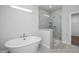 Spa-like bathroom featuring a freestanding tub and a glass-enclosed walk-in shower at 98 Priming Way, Angier, NC 27501