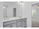 Bright bathroom featuring a double sink vanity with gray cabinets and contemporary fixtures at 98 Priming Way, Angier, NC 27501