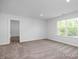 Bright bedroom with large windows and neutral carpeting at 98 Priming Way, Angier, NC 27501