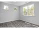 Bright bedroom with hardwood floors, base trim and multiple windows that bring in natural light at 98 Priming Way, Angier, NC 27501