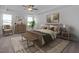 Comfortable bedroom with a tray ceiling, warm decor, and natural light at 98 Priming Way, Angier, NC 27501