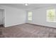Spacious bedroom with carpet, white walls, and two windows at 98 Priming Way, Angier, NC 27501