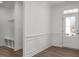 Bright entryway with wainscoting, hall tree and view of the front door at 98 Priming Way, Angier, NC 27501
