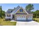 Beautiful stone and siding exterior with a three-car garage and well-manicured lawn at 98 Priming Way, Angier, NC 27501