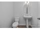 Well-lit half bathroom with a pedestal sink and modern fixtures at 98 Priming Way, Angier, NC 27501