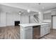 Modern kitchen with an island, stainless steel dishwasher, and open access to the living room at 98 Priming Way, Angier, NC 27501