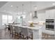 Bright, open kitchen with stainless steel appliances, marble countertops, and a large island at 98 Priming Way, Angier, NC 27501