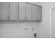 Clean laundry room with upper cabinets for storage at 98 Priming Way, Angier, NC 27501