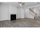 Open living room featuring a fireplace and staircase at 98 Priming Way, Angier, NC 27501