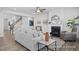 Well-lit living room with hardwood floors, fireplace and a ceiling fan at 98 Priming Way, Angier, NC 27501
