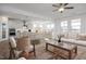Open floor plan featuring a modern kitchen, dining area, and living room with ample natural light at 98 Priming Way, Angier, NC 27501