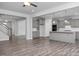 Open-concept living room featuring wood floors, recessed lighting, and seamless transition to the kitchen and staircase at 98 Priming Way, Angier, NC 27501