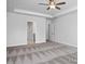 Carpeted primary bedroom with tray ceiling, ceiling fan and open doorway at 98 Priming Way, Angier, NC 27501