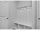 Neat mudroom with built-in bench, cubbies, and coat hooks at 98 Priming Way, Angier, NC 27501