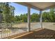 View from the porch, showcasing a wooden deck and screened railing, overlooking the surrounding landscape at 98 Priming Way, Angier, NC 27501