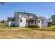 Rear exterior of the home with a screened porch and spacious lawn at 98 Priming Way, Angier, NC 27501