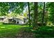 Serene backyard view features a detached garage and lush green surroundings at 1006 Apache Ln, Apex, NC 27502