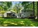 Spacious backyard features a detached garage, ample lawn space, and mature trees for privacy at 1006 Apache Ln, Apex, NC 27502