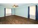 Large bedroom with hardwood floors, ceiling fan, light blue walls, and windows with curtains at 1006 Apache Ln, Apex, NC 27502
