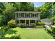 Charming two-story home featuring a well-manicured lawn, mature trees, and a detached garage at 1006 Apache Ln, Apex, NC 27502
