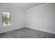 Bedroom featuring gray wood-look flooring and a window looking out onto a green landscape at 1041 Bonanza Ln # 37, Mebane, NC 27302