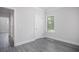 Bedroom featuring gray wood-look flooring, a window, and an interior door at 1041 Bonanza Ln # 37, Mebane, NC 27302