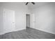 This bedroom has gray wood-look flooring, a vaulted ceiling, and two doors at 1041 Bonanza Ln # 37, Mebane, NC 27302
