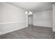 Elegant dining room with modern chandelier, white trim, and beautiful flooring at 1041 Bonanza Ln # 37, Mebane, NC 27302