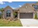 Beautiful brick home showcasing a two-car garage, manicured landscaping, and a welcoming entrance at 1041 Bonanza Ln # 37, Mebane, NC 27302