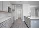 Well-lit kitchen featuring grey cabinetry, white countertops, subway tile, and modern stainless steel appliances at 1041 Bonanza Ln # 37, Mebane, NC 27302