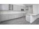 Charming kitchen with grey cabinets, stainless steel microwave, and island with seating for modern living at 1041 Bonanza Ln # 37, Mebane, NC 27302