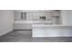 Modern kitchen with grey cabinets, subway tile backsplash, and an island with a white countertop at 1041 Bonanza Ln # 37, Mebane, NC 27302
