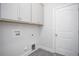 Functional laundry room with overhead cabinets, washer/dryer hookups, and a convenient access door at 1041 Bonanza Ln # 37, Mebane, NC 27302
