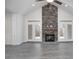 Spacious living room showcasing a floor-to-ceiling stone fireplace, vaulted ceiling, and natural light at 1041 Bonanza Ln # 37, Mebane, NC 27302