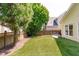 Spacious artificial turf backyard with mature trees and seating area at 105 Bridgegate Dr, Cary, NC 27519